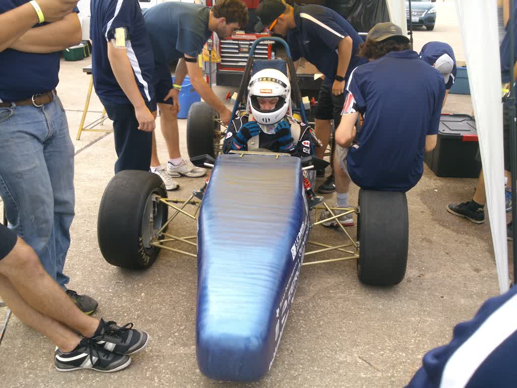 A driver preparing for race inspection